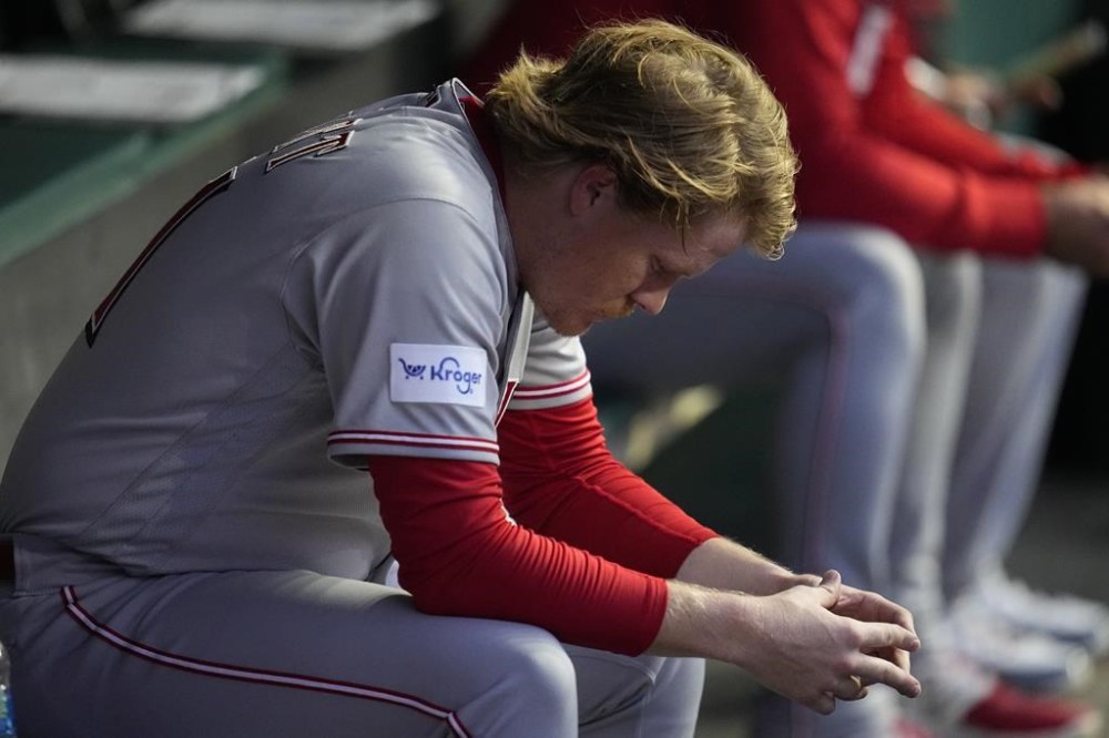 Cincinnati Reds starting pitcher Andrew Abbott sits in the dugout after being removed during the third inning of the team's baseball game against the Cleveland Guardians, Wednesday, Sept. 27, 2023, in Cleveland. (AP Photo/Sue Ogrocki)