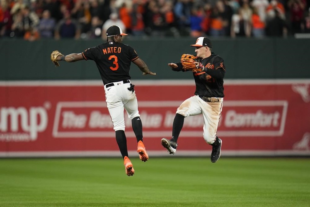 Baltimore Orioles shortstop Jorge Mateo (3) and left fielder Austin Hays (21) react after a baseball game against the Washington Nationals, Wednesday, Sept. 27, 2023, in Baltimore. The Orioles won 5-1. (AP Photo/Julio Cortez)