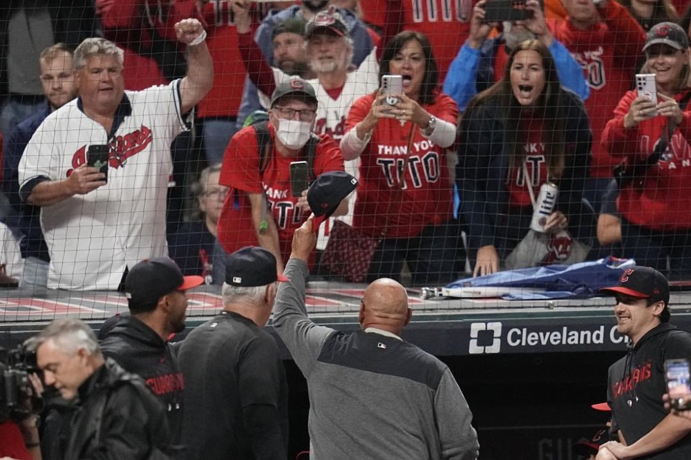 Cleveland Guardians manager Terry Francona, center, waves his cap to fans after the Guardians defeated the Cincinnati Reds in a baseball game Wednesday, Sept. 27, 2023, in Cleveland. (AP Photo/Sue Ogrocki)