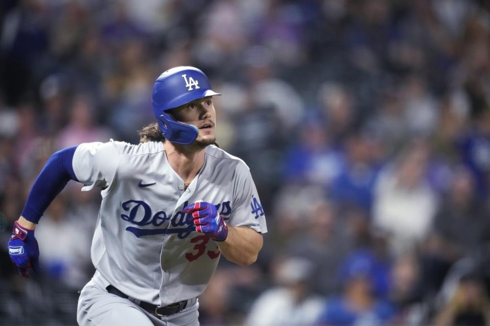 Los Angeles Dodgers' James Outman watches his solo home run off Colorado Rockies starting pitcher Noah Davis during the third inning of a baseball game Wednesday, Sept. 27, 2023, in Denver. (AP Photo/David Zalubowski)