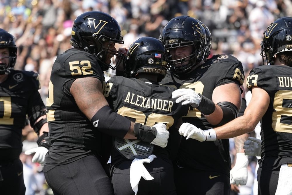 Vanderbilt offensive linemen Kevo Wesley (52) and Julian Hernandez, right, congratulate running back Sedrick Alexander, center, after his touchdown against Kentucky in the first half of an NCAA college football game Saturday, Sept. 23, 2023, in Nashville, Tenn. (AP Photo/George Walker IV)