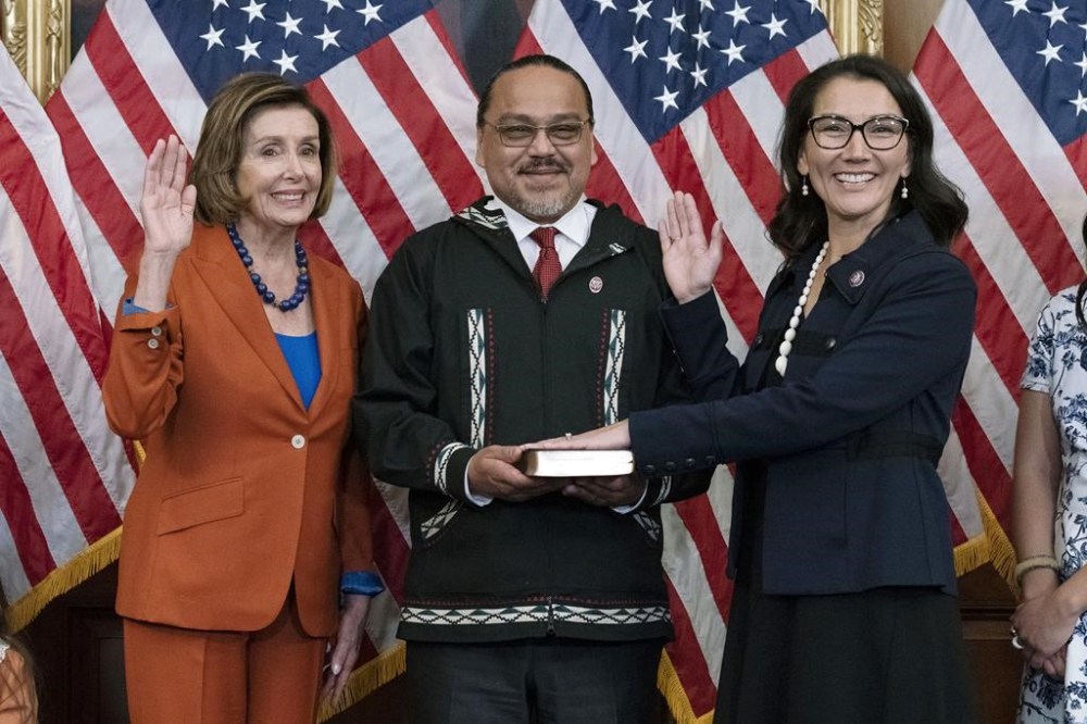 FILE - Speaker of the House Nancy Pelosi of Calif., left, administers the House oath of office to Rep. Mary Peltola, D-Alaska, standing next to her husband Eugene