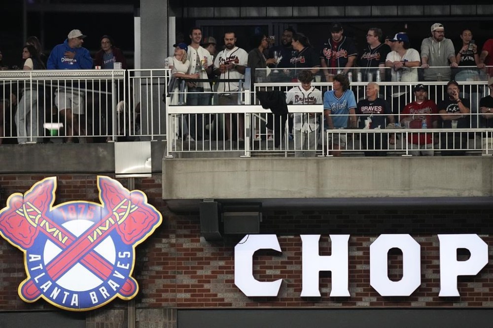 Fans watch a baseball game between Chicago Cubs and Atlanta Braves from the The Chop House above right field at Truist Park on Wednesday, Sept. 27, 2023, in Atlanta. Major League Baseball attendance is on track to increase about 9% and top 70 million for the first time since 2017, helped by a full offseason of sales, digital ticketing and increased social gathering spaces in stadiums.(AP Photo/John Bazemore)