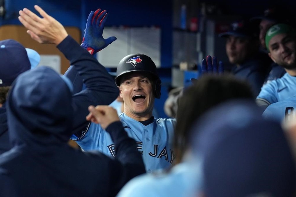 Toronto Blue Jays third baseman Matt Chapman (26) celebrates with teammates after scoring on a solo home run during the fourth inning MLB baseball action against the New York Yankees, in Toronto, Thursday, Sept. 28, 2023. THE CANADIAN PRESS/Chris Young