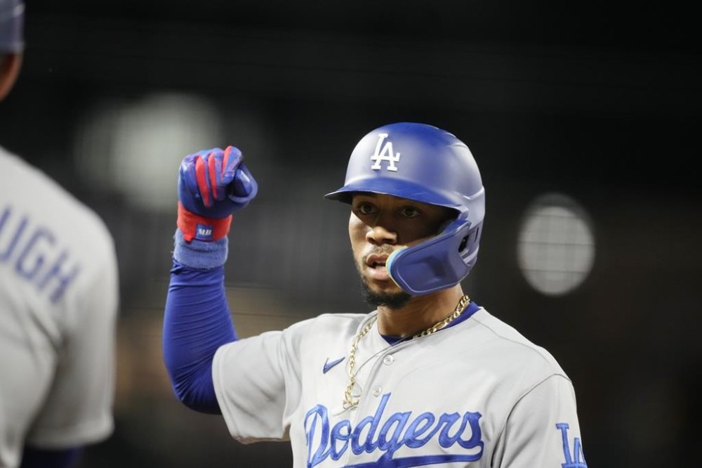 Los Angeles Dodgers' Mookie Betts gestures after his RBI single against Colorado Rockies starting pitcher Noah Davis in the fifth inning of a baseball game Wednesday, Sept. 27, 2023, in Denver. (AP Photo/David Zalubowski)