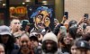 FILE - An image of the late rapper and actor Tupac Shakur appears among fans during a ceremony honoring Shakur with a star on the Hollywood Walk of Fame on Wednesday, June 7, 2023, in Los Angeles. The unsolved killing of Shakur has taken a major turn. Duane “Keffe D” Davis was arrested Friday morning, although the exact charge or charges were not immediately clear, according to two officials with first-hand knowledge of the arrest. The renewed activity comes nearly 30 years after Shakur was gunned down on Sept. 7, 1996. (AP Photo/Chris Pizzello, File)