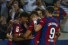 Barcelona players celebrate after Sevilla's Sergio Ramos scores an own goal past his goalkeeper during a Spanish La Liga soccer match between Barcelona and Sevilla, at the Olympic Stadium of Montjuic in Barcelona, Spain, Friday, Sept. 29, 2023. (AP Photo/Joan Monfort)