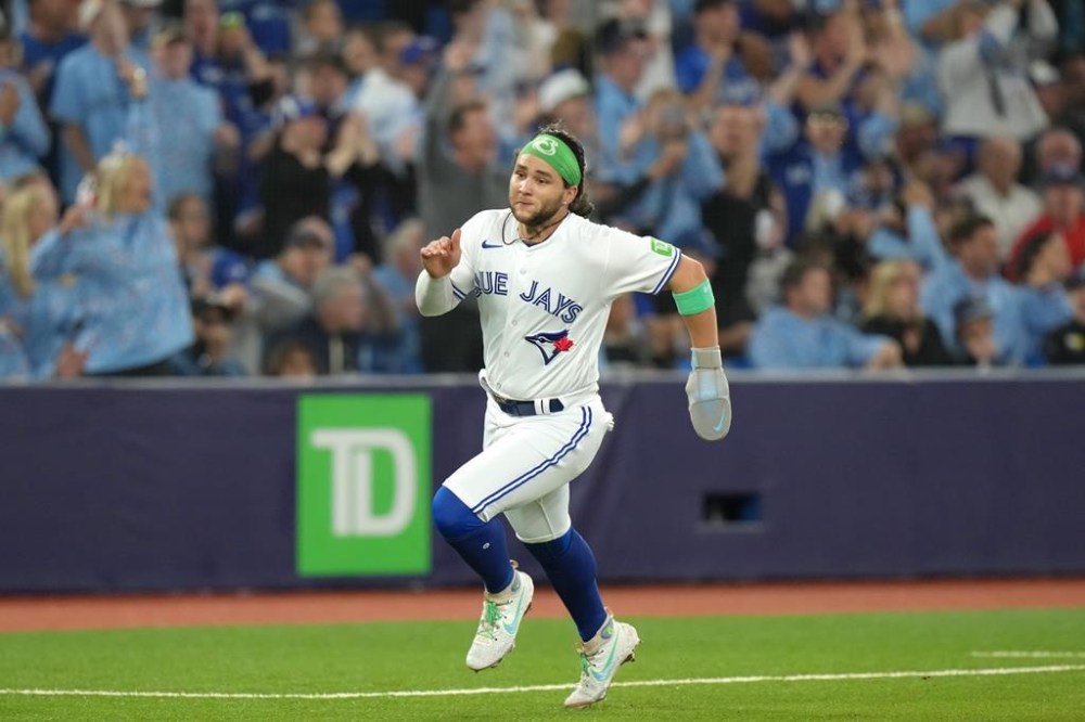 Toronto Blue Jays' Bo Bichette closes in on home plate to score off a two run homer from teammate Cavan Baggio, not shown, during fourth inning American League MLB baseball action against Tampa Bay Rays in Toronto, Friday, Sept. 29, 2023. THE CANADIAN PRESS/Chris Young
