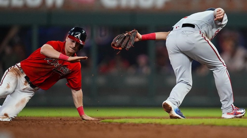 Atlanta Braves' Luke Williams (67) moves around Washington Nationals second baseman Luis Garcia's tag during third inning of a baseball game, Friday, Sept. 29, 2023, in Atlanta. (AP Photo/Mike Stewart)