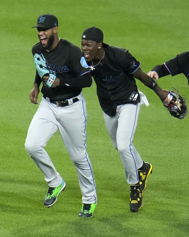 Miami Marlins center fielder Jazz Chisholm Jr., right, and Bryan De La Cruz celebrate after getting the final out of a win over the Pittsburgh Pirates in a baseball game in Pittsburgh, Friday, Sept. 29, 2023. (AP Photo/Gene J. Puskar)