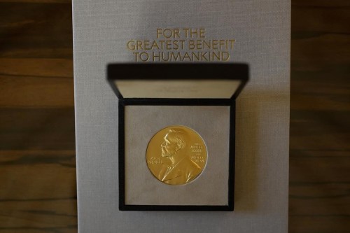 FILE - The 2021 Nobel Prize for Literature medal presented to Abdulrazak Gurnah, a Tanzanian-born novelist and emeritus professor who lives in the UK, is displayed before a ceremony to present to him at the Swedish Ambassador's Residence in London, Monday, Dec. 6, 2021. The start of October is when the Nobel committees get together in Stockholm and Oslo to announce the winners of the yearly awards. (AP Photo/Matt Dunham, File)