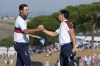 Europe's Viktor Hovland, right, shakes hands with United States' Scottie Scheffler on the 11th green, Europe won the match 9&7 in their morning Foursomes match at the Ryder Cup golf tournament at the Marco Simone Golf Club in Guidonia Montecelio, Italy, Saturday, Sept. 30, 2023. (AP Photo/Gregorio Borgia )
