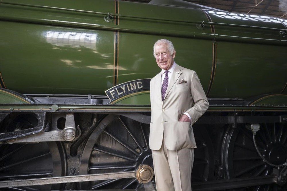 FILE - Britain's King Charles III stands by the Flying Scotsman, a historical locomotive, at Pickering Heritage Railway Station, the southern terminus of the North Yorkshire Moors Railway, for a visit to Pickering in Yorkshire, England, Monday, June 12, 2023. Several people were injured after the Flying Scotsman, the historic steam locomotive, was involved in a “low speed” crash with another heritage train in the Scottish Highlands on Friday, Sept. 29, 2023. (Charlotte Graham/Pool Photo via AP, File)