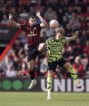 Bournemouth's Lewis Cook left, and Arsenal's Martin Odegaard battle for the ball during their English Premier League soccer match at the Vitality Stadium, Bournemouth, England, Saturday, Sept. 30, 2023. (Robbie Stephenson/PA via AP)