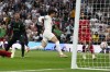 Tottenham's Son Heung-min, center, scores his side's opening goal during the English Premier League soccer match between Tottenham Hotspur and Liverpool at the Tottenham Hotspur Stadium, in London, England, Saturday, Sept. 30, 2023. (AP Photo/Alberto Pezzali)