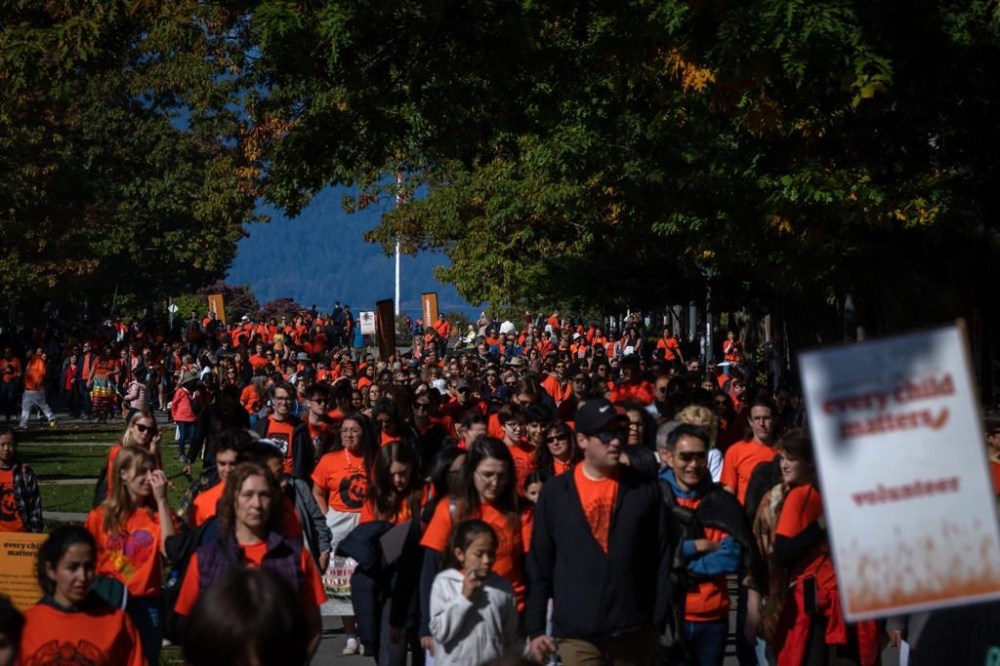 People march together at the University of British Columbia for National Day for Truth and Reconciliation in Vancouver, B.C., Saturday, Sept. 30, 2023. The federal statutory holiday recognizes abuses suffered by Inuit, First Nations and Metis people at hundreds of state and church-run residential schools. THE CANADIAN PRESS/Ethan Cairns