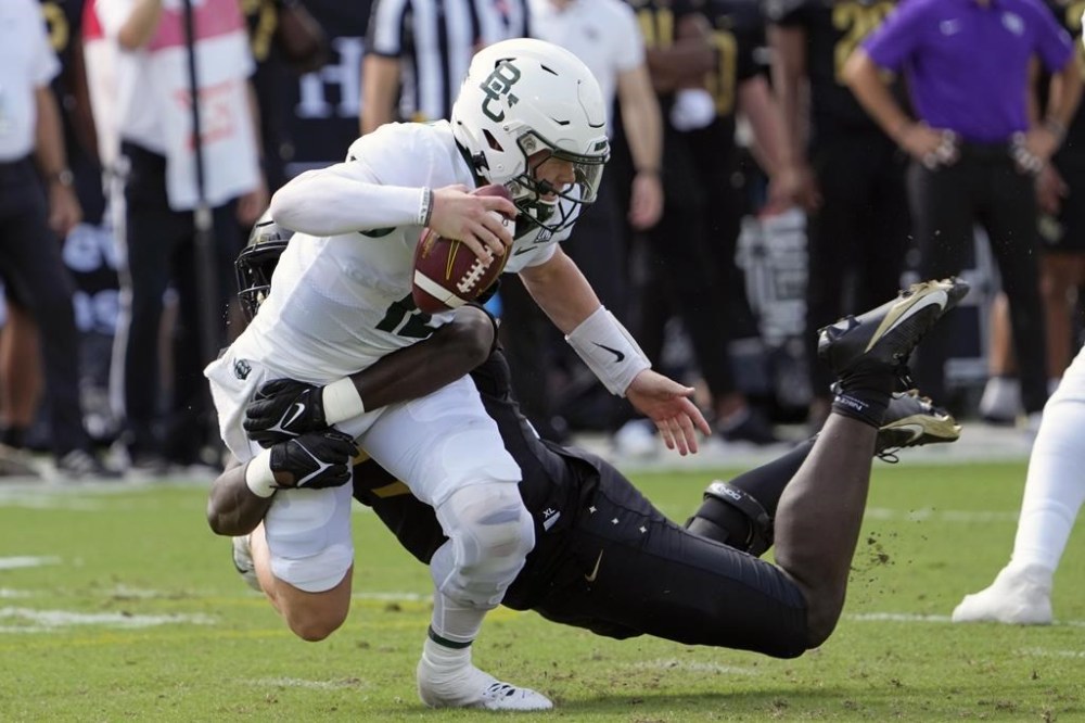 Baylor quarterback Blake Shapen, left, is sacked by Central Florida defensive end Malachi Lawrence during the first half of an NCAA college football game, Saturday, Sept. 30, 2023, in Orlando, Fla. (AP Photo/John Raoux)