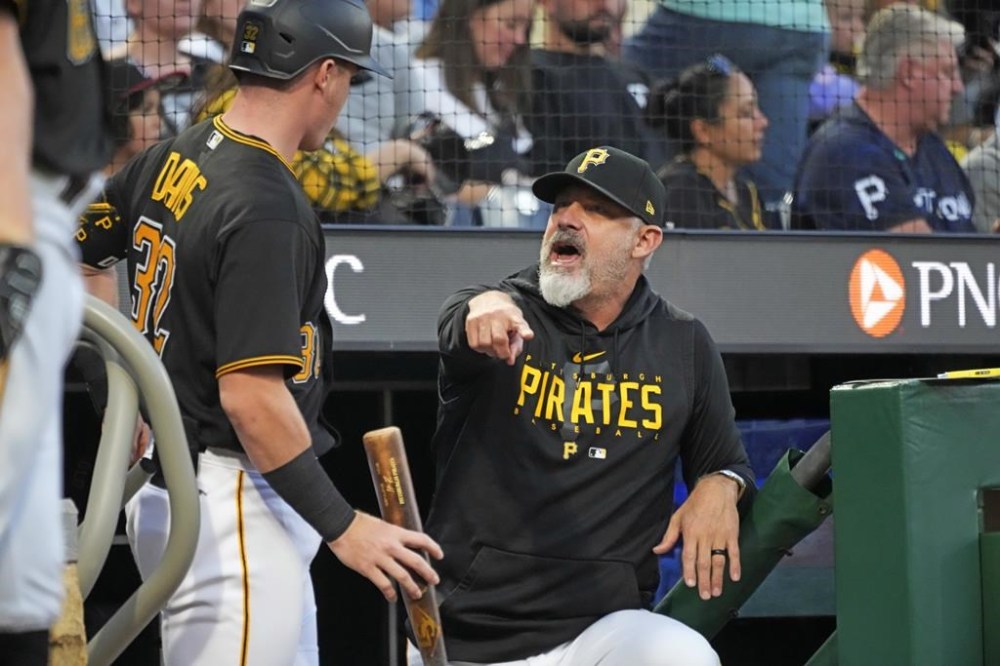 Pittsburgh Pirates' Derek Shelton, right, talks with Henry Davis during a baseball game against the Miami Marlins in Pittsburgh, Saturday, Sept. 30, 2023. (AP Photo/Gene J. Puskar)