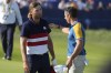 Europe's Rory McIlroy, right,shakes hands with United States' Sam Burns after winning his singles match 3&1 on the 17th green at the Ryder Cup golf tournament at the Marco Simone Golf Club in Guidonia Montecelio, Italy, Sunday, Oct. 1, 2023. (AP Photo/Gregorio Borgia)