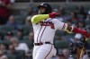 Atlanta Braves designated hitter Marcell Ozuna hits a three-run home run in the third inning of a baseball game against the Washington Nationals, Sunday, Oct. 1, 2023, in Atlanta. (AP Photo/John Bazemore)