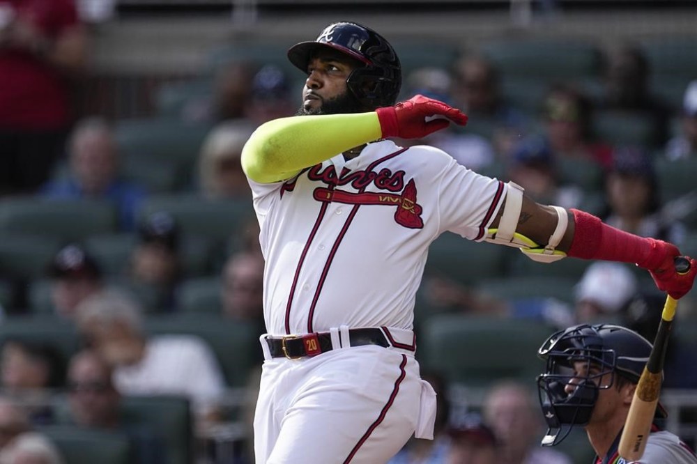 Atlanta Braves designated hitter Marcell Ozuna hits a three-run home run in the third inning of a baseball game against the Washington Nationals, Sunday, Oct. 1, 2023, in Atlanta. (AP Photo/John Bazemore)