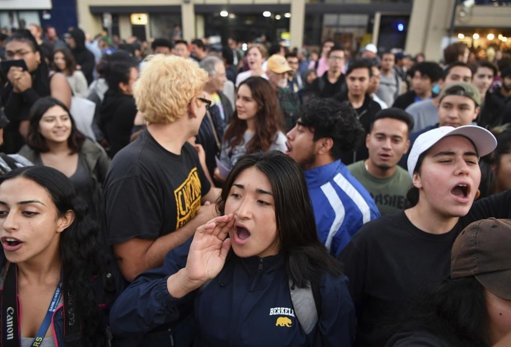 FILE - Protesters shout before a speaking engagement by Ben Shapiro on the campus of the University of California Berkeley in Berkeley, Calif., Sept. 14, 2017. New polling finds that America’s college campuses are seen as far friendlier to liberals than to conservatives when it comes free speech. Polling from the University of Chicago and the AP-NORC Center for Public Affairs Research finds that 47% of adult Americans say liberals are free to express their views on college campuses, while 20% said the same of conservatives. (AP Photo/Josh Edelson, File)
