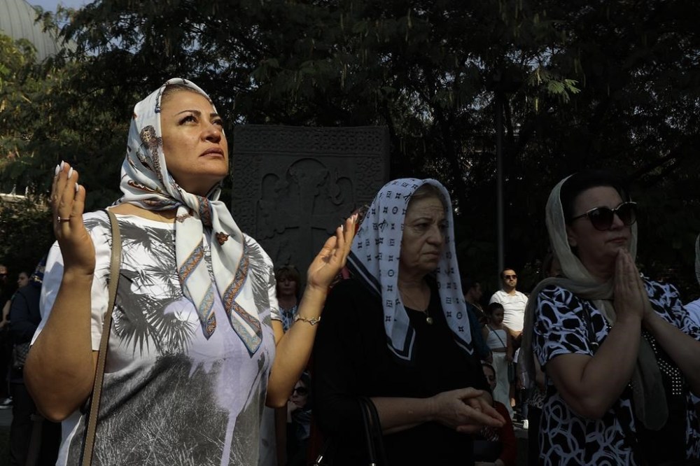 Armenian parishioners attend a national day of prayer for Artsakh (Nagorno-Karabakh) leading by Armenian Catholicos Karekin II at the Armenian Apostolic Cathedral in Etchmiadzin, the seat of the Oriental Orthodox church outside in Yerevan, Armenia, Sunday, Oct. 1, 2023. Armenia's government says an ethnic Armenian exodus has nearly emptied Nagorno-Karabakh of residents since Azerbaijan attacked and ordered the breakaway region's militants to disarm. (AP Photo/Vasily Krestyaninov)