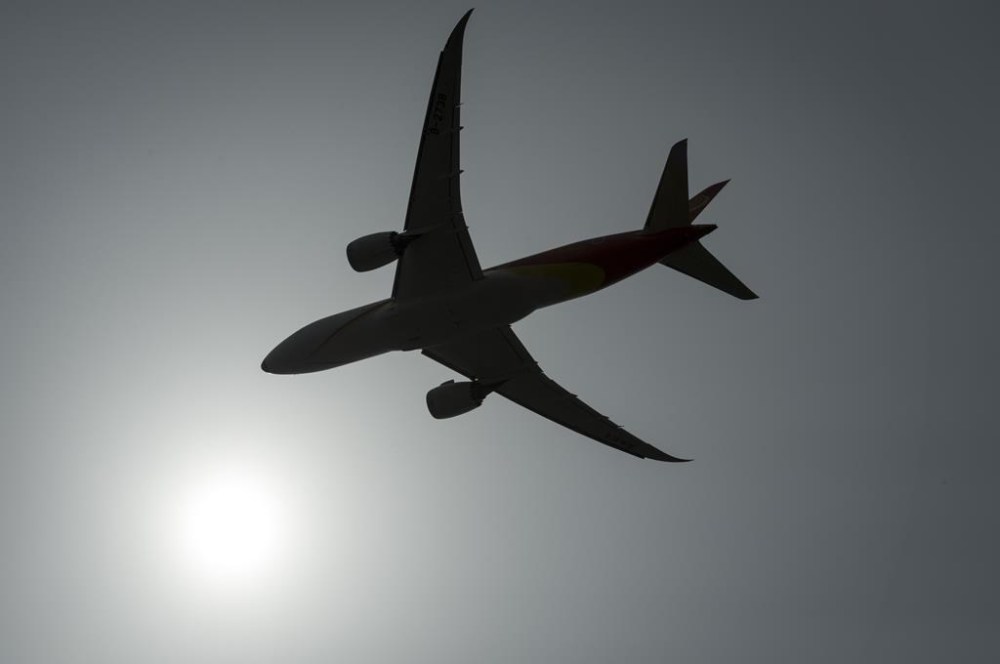 A plane is silhouetted as it takes off from Vancouver International Airport in Richmond, B.C., on May 13, 2019. THE CANADIAN PRESS/Jonathan Hayward