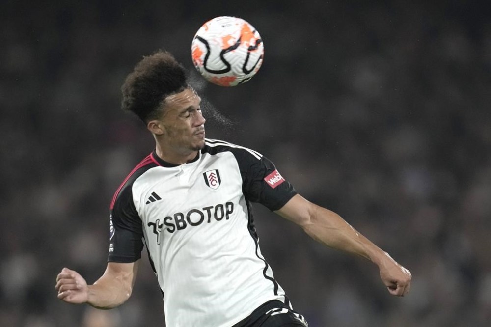 Fulham's Antonee Robinson heads the ball during the English Premier League soccer match between Fulham and Chelsea at Craven Cottage in London, Monday, Oct. 2, 2023. (AP Photo/Kin Cheung)