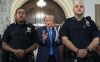 Former President Donald Trump speaks with journalists during a midday break from court proceedings in New York, Monday, Oct. 2, 2023, as he attends the start of a civil trial in a lawsuit that already has resulted in a judge ruling that he committed fraud in his business dealings. (AP Photo/Craig Ruttle)