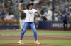 Sandra Gonzalez, mother of Tampa Bay Rays left fielder Randy Arozarena throws out the first pitch before a AL wild-card baseball playoff series game between the Tampa Bay Rays and Texas Rangers, Tuesday, Oct. 3, 2023, in St. Petersburg, Fla. (AP Photo/John Raoux)
