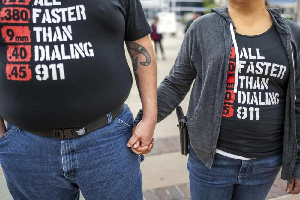 FILE - Albuquerque residents Michael Caldwell, left, and his wife, Natasha Caldwell, attend a Second Amendment Protest in response to Gov. Michelle Lujan Grisham's recent public health order suspending the conceal and open carry of guns in and around Albuquerque for 30-days, Tuesday, Sept. 12, 2023, in Albuquerque, N.M. Natasha said