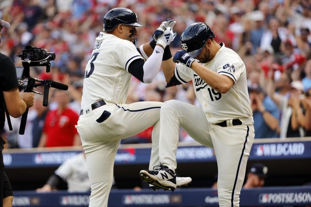 Minnesota Twins' Royce Lewis, left, celebrates his two-run home run with Alex Kirilloff (19) during the first inning in Game 1 of an AL wild-card baseball playoff series against the Toronto Blue Jays Tuesday, Oct. 3, 2023, in Minneapolis. (AP Photo/Bruce Kluckhohn)