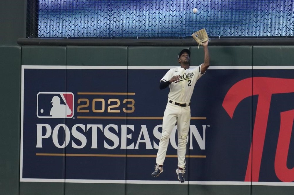 Minnesota Twins center fielder Michael A. Taylor makes a leaping catch at the wall on a fly ball from Toronto Blue Jays' Matt Chapman during the sixth inning in Game 1 of an AL wild-card baseball playoff series Tuesday, Oct. 3, 2023, in Minneapolis. (AP Photo/Abbie Parr)