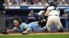 Toronto Blue Jays' Bo Bichette, left, is tagged out at home plate by Minnesota Twins catcher Ryan Jeffers on a fielder's choice after an infield single by Kevin Kiermaier during the fourth inning in Game 1 of an AL wild-card baseball playoff series Tuesday, Oct. 3, 2023, in Minneapolis. (AP Photo/Abbie Parr)