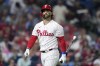 Philadelphia Phillies' Bryce Harper walks to the dugout after striking out against Miami Marlins pitcher A.J. Puk during the fifth inning of Game 1 in an NL wild-card baseball playoff series, Tuesday, Oct. 3, 2023, in Philadelphia. (AP Photo/Matt Slocum)