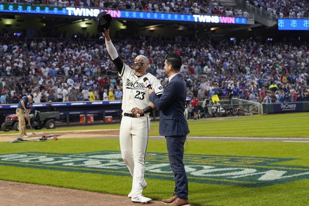 Minnesota Twins' Royce Lewis celebrates as he is interviewed after a 3-1 win over the Toronto Blue Jays in Game 1 of an AL wild-card baseball playoff series Tuesday, Oct. 3, 2023, in Minneapolis. (AP Photo/Abbie Parr)