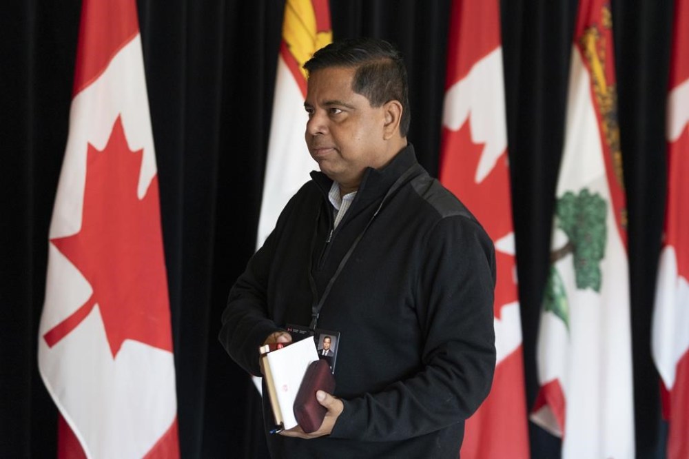 Minister of Crown-Indigenous Relations Gary Anandasangaree walks past members of the media during the Liberal Cabinet retreat in Charlottetown, Tuesday, Aug. 22, 2023. THE CANADIAN PRESS/Darren Calabrese