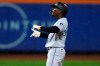 Miami Marlins' Jazz Chisholm Jr. gestures towards teammates after hitting an RBI double during the ninth inning of a baseball game against the New York Mets as rain falls Thursday, Sept. 28, 2023, in New York. (AP Photo/Frank Franklin II)