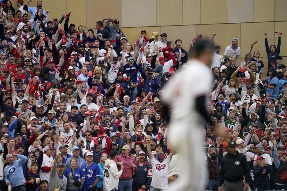 Fan react after Minnesota Twins pitcher Sonny Gray, foreground, pick offed Toronto Blue Jays' Vladimir Guerrero Jr. at second base during the fifth inning of Game 2 of an AL wild-card baseball playoff series Wednesday, Oct. 4, 2023, in Minneapolis. (AP Photo/Abbie Parr)