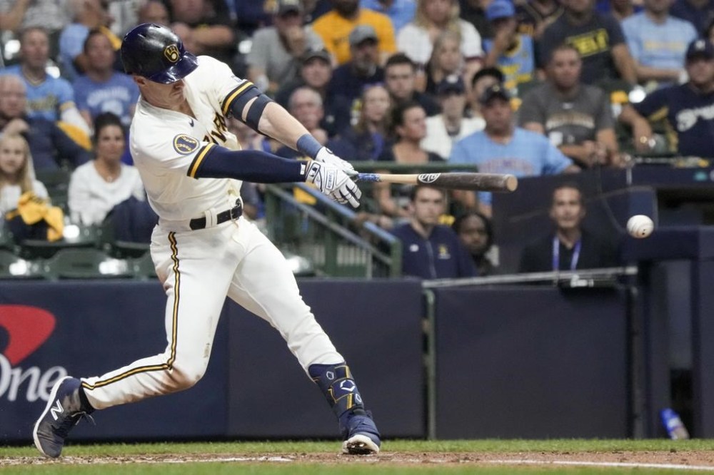 Milwaukee Brewers' Mark Canha hits a single during the third inning of a Game 2 of their National League wildcard baseball series against the Arizona Diamondbacks Wednesday, Oct. 4, 2023, in Milwaukee. (AP Photo/Morry Gash)