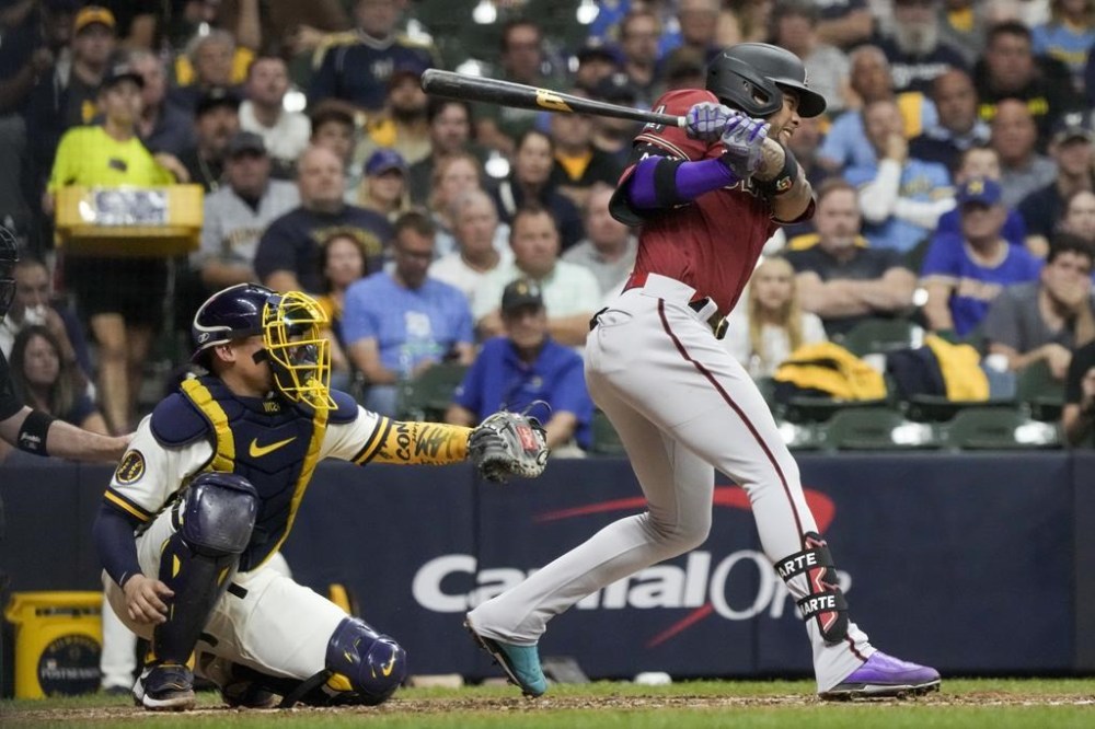 Arizona Diamondbacks' Ketel Marte gets a two-run scoring hit during the sixth inning of a Game 2 of their National League wildcard baseball series against the Milwaukee Brewers Wednesday, Oct. 4, 2023, in Milwaukee. (AP Photo/Morry Gash)