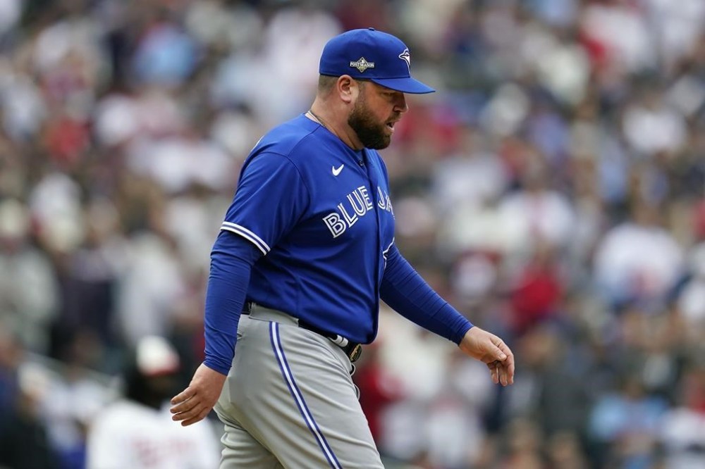 Toronto Blue Jays manager John Schneider walks to the mound to make a pitching change during the fourth inning of Game 2 of an AL wild-card baseball playoff series against the Minnesota Twins Wednesday, Oct. 4, 2023, in Minneapolis. (AP Photo/Abbie Parr)