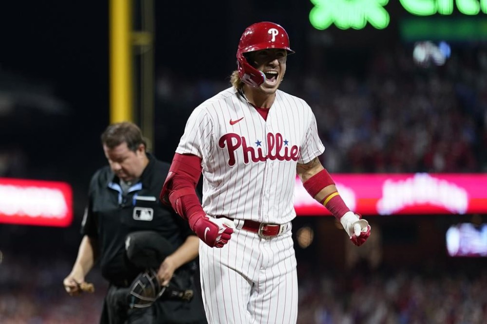 Philadelphia Phillies' Bryson Stott reacts after hitting a grand slam against Miami Marlins pitcher Andrew Nardi during the sixth inning of Game 2 in an NL wild-card baseball playoff series, Wednesday, Oct. 4, 2023, in Philadelphia. (AP Photo/Matt Slocum)