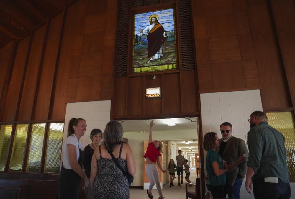 A young girl jumps to touch the doorway to the sanctuary of First Baptist Church in Mt. Vernon, Ill., Sunday, Sept. 10, 2023. (AP Photo/Jessie Wardarski)