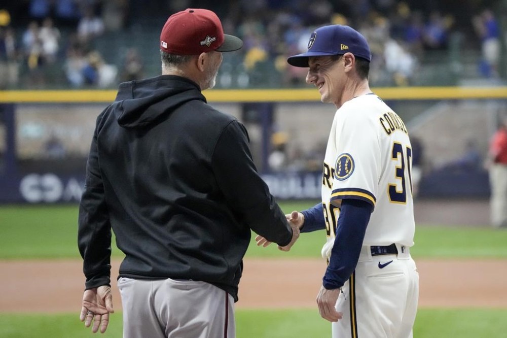 Milwaukee Brewers manager Craig Counsell and Arizona Diamondbacks manager Torey Lovullo before a Game 1 of their National League wildcard baseball game Tuesday, Oct. 3, 2023, in Milwaukee. (AP Photo/Morry Gash)