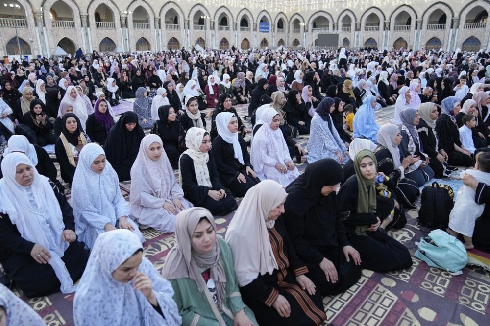 FILE - Muslims perform Eid prayers on the first day of Eid al-Adha holiday at the Sunni shrine of Abdul-Qadir al-Gailani in Baghdad, Iraq, Wednesday, June 28, 2023. In the Middle East and North Africa, where religion is often ingrained in daily life's very fabric, rejecting faith can come with social or other repercussions, so many of the