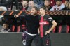 Leverkusen's head coach Xabi Alonso talks to Leverkusen's Jonas Hofmann before he is changed in during the UEFA Europa League Group H soccer match between Bayer Leverkusen and BK Haecken at the BayArena in Leverkusen, Germany, Thursday, Sept. 21, 2023. (AP Photo/Martin Meissner)