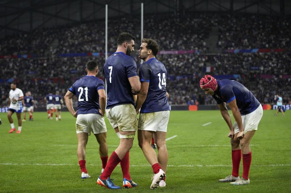 France's Charles Ollivon, second left, greets hands with France's Damian Penaud after scoring a try during the Rugby World Cup Pool A match between France and Namibia at the Stade de Marseille in Marseille, France, Thursday, Sept. 21, 2023. (AP Photo/Daniel Cole)