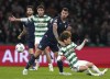 Lazio's Alessio Romagnoli, second right, brings down Celtic's Kyogo Furuhashi during the Champions League Group E soccer match between Celtic and Lazio at Celtic Park, Glasgow, Scotland, Wednesday, Oct. 4, 2023. (Andrew Milligan/PA via AP)